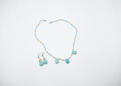 A beaded necklace with multicolored beads and turquoise pendants