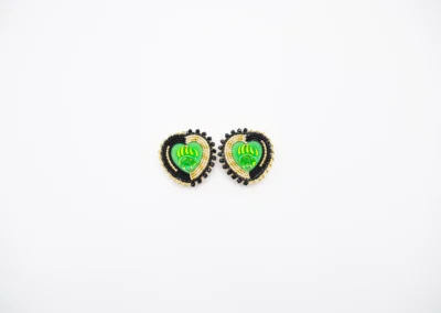 Colorful beaded earrings in heart shape, featuring green patterns and black accents, embellished with gold beads.
